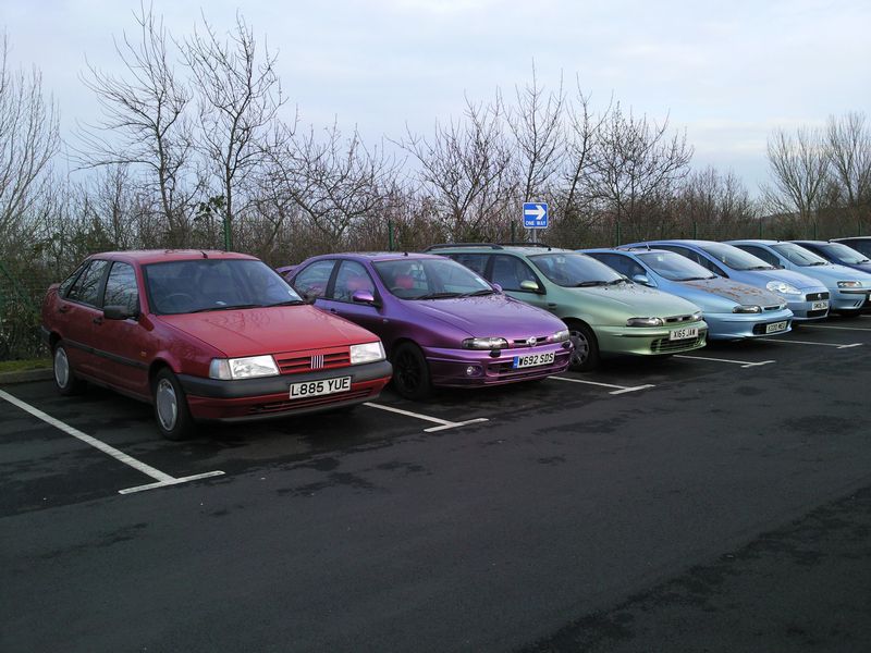 The randomly coloured cars bringing up the rear